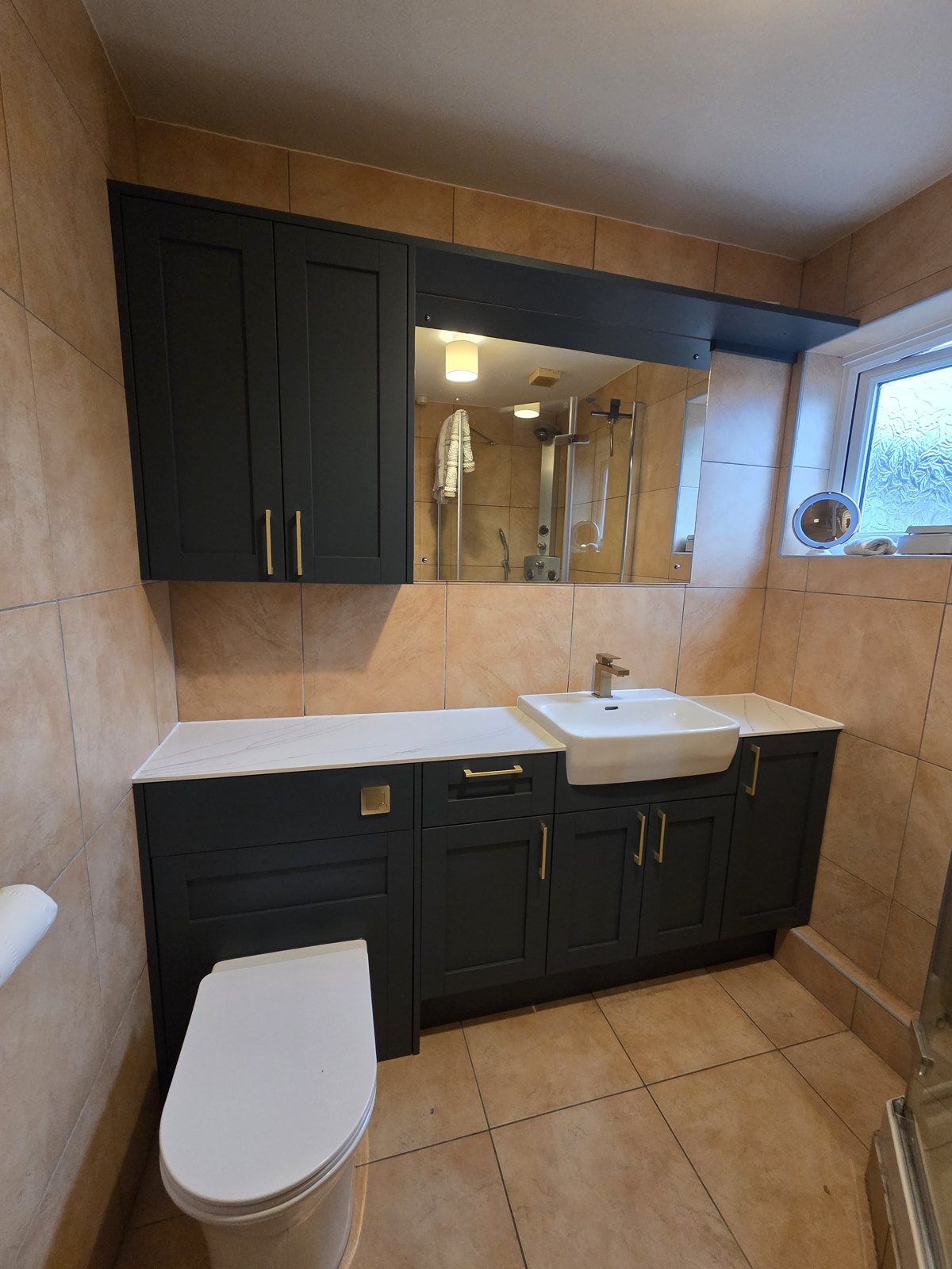Fitted bathroom furniture with basin unit, mirrored wall cabinets and WC surround
