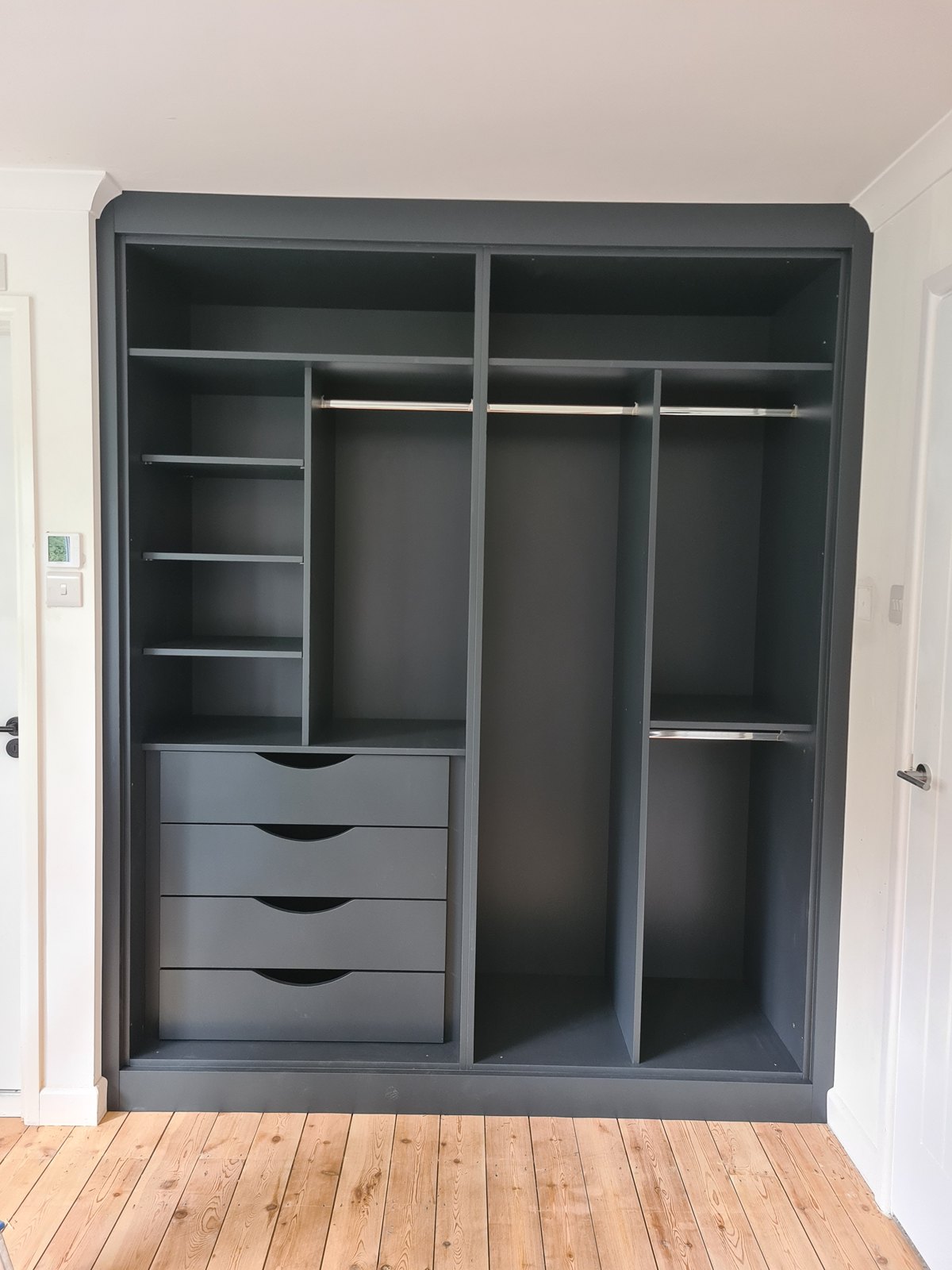 Wardrobe interior fitted out with drawers, shelving and hanging rails