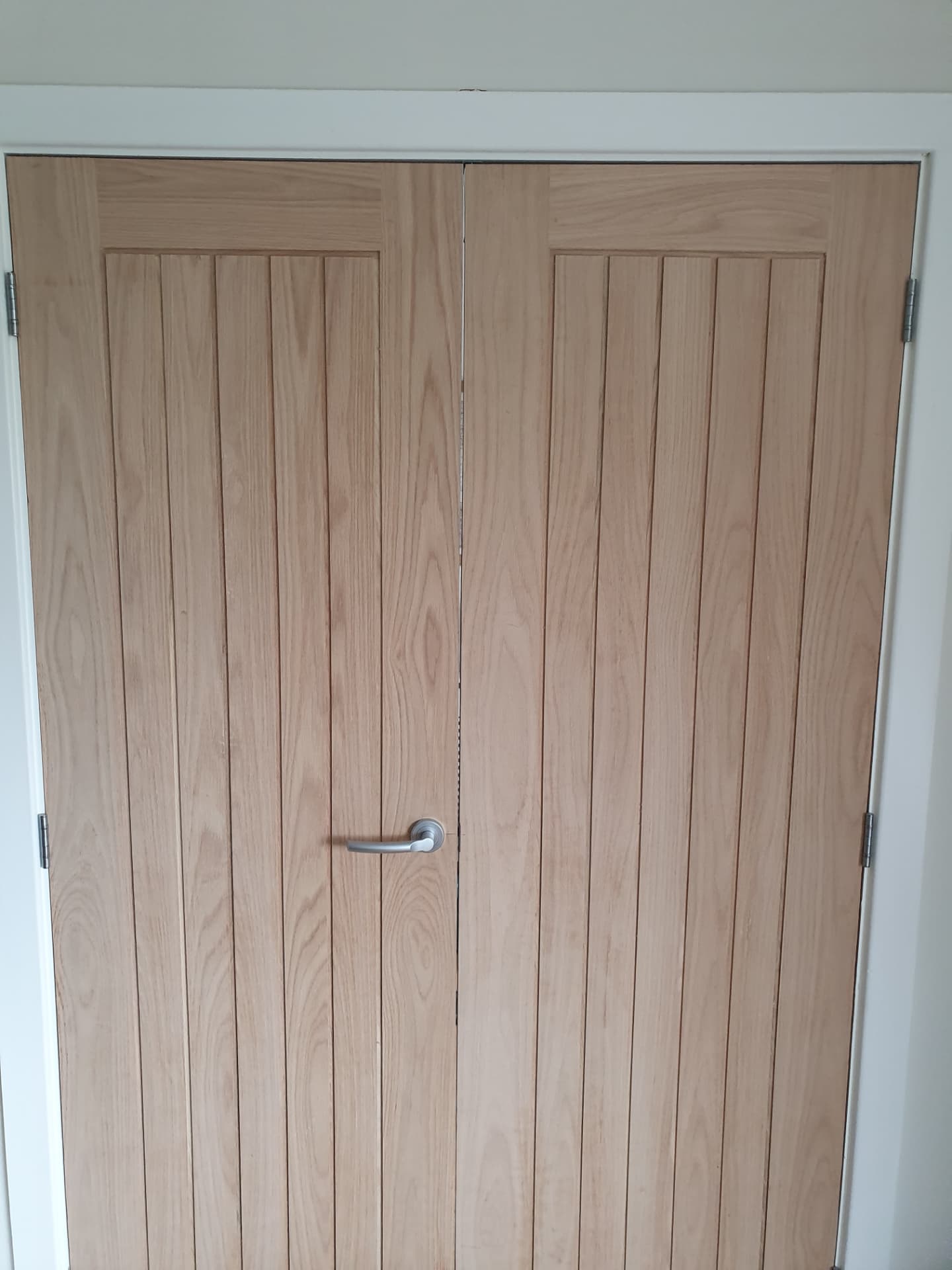 Pair of oak cottage-style internal doors fitted within a white frame