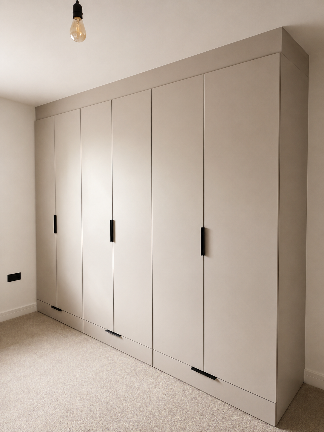 Wren greige fitted wardrobes with integrated drawers and matte black handles