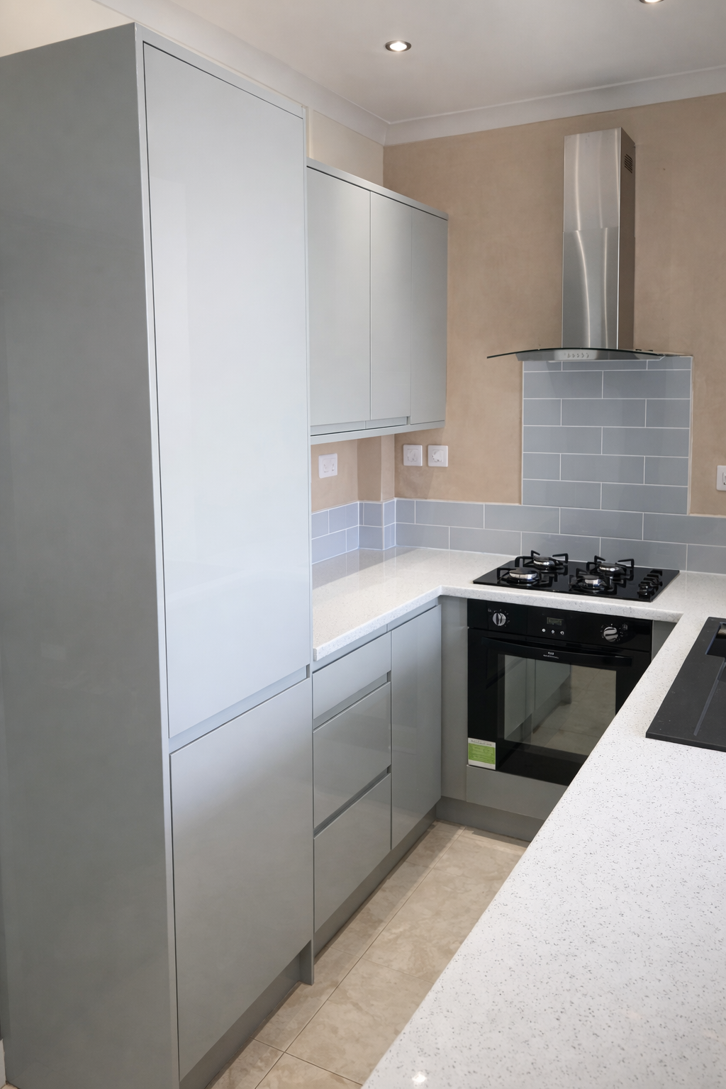 Compact high-gloss grey U-shaped kitchen with larder unit